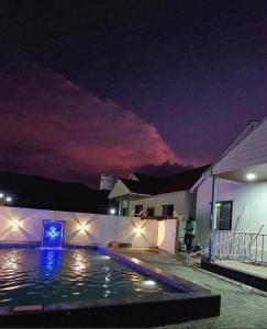 a house with a swimming pool at night at Indraprastha villa in Malavli +4 photos