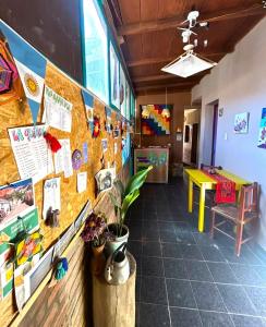 a room with a wall with many pictures on it at Hostal Humahuaca in Humahuaca
