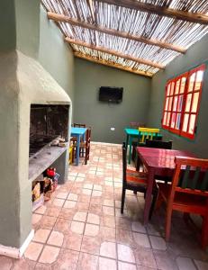 a dining room with a table and a fireplace at Hostal Humahuaca in Humahuaca