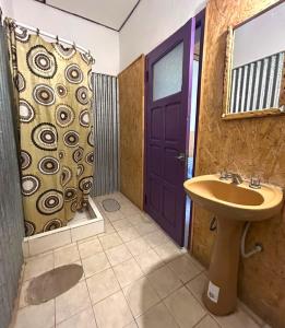a bathroom with a sink and a purple door at Hostal Humahuaca in Humahuaca +16 photos
