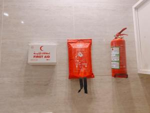 a fire hydrant and a first aid bag on the floor at شقق ضوء القمر Moonlight Apartment in Rahwat al Barr