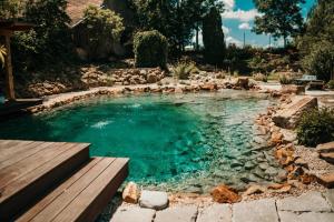 a swimming pool in the middle of a yard at Hostinec U Rypáka in Vrátkov