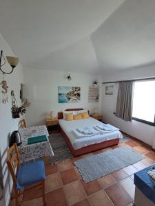 a bedroom with a large bed and a table at Resort "Maslinjak" in Budva +195 photos