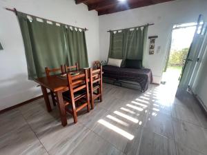 a room with a table and chairs and a bed at EBC SUM&Aparts in San Miguel del Monte