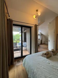 a bedroom with a dog laying on a bed at Charmante maison indépendante avec jardin, 45 m2, clim, parking in Mondeville