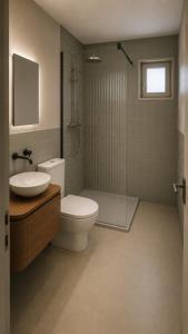 a bathroom with a toilet and a sink and a shower at Eiger View in Grindelwald
