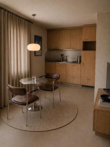 a kitchen with a table and chairs in a room at Eiger View in Grindelwald