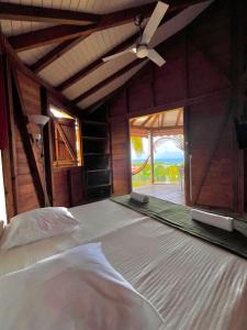 a bedroom with a bed and a ceiling fan at Baobab in Sainte-Anne +16 photos