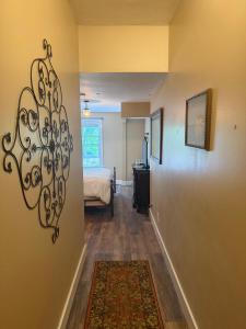 a hallway with a room with a bed and a rug at Inn at Harbour Village in Ilwaco
