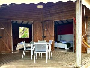 a room with a table and chairs and a bedroom at Baobab in Sainte-Anne
