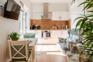 a living room with a couch and a kitchen at Lou-Lou in Zandvoort