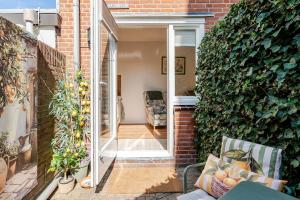 an open door to a room with a brick wall at Lou-Lou in Zandvoort