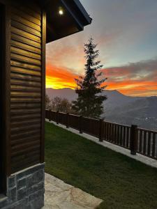 a view of a sunset from a house with a tree at Ötüken Dağ Evleri in Akcaabat