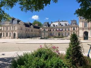 a large building with a tree in front of it at La Joueuse, Et pop Et Chic ! in Poitiers