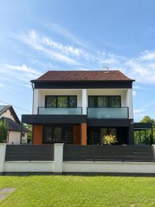 a large house with a red roof at Barcs Thermal Apartments in Barcs
