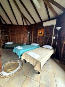 a bedroom with two beds in a room at Baobab in Sainte-Anne