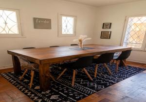 a wooden table in a room with chairs around it at Casa Tribu in Viña del Mar +25 photos