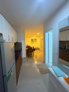 a kitchen with a refrigerator and a dining room at Florida apartments in Golem +10 photos