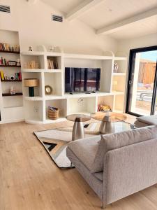 a living room with a couch and a table at Doudou House in Saint-Denis-dʼOléron