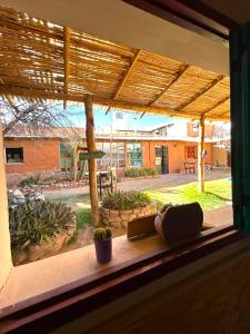 a window with a view of a courtyard at Hostal Humahuaca in Humahuaca
