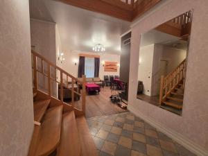 a hallway with wooden stairs and a living room at Lodja Jahimaja in Pärnumaa +48 photos