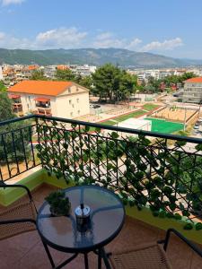 a balcony with a table and a view of a city at The View Xanthi in Xanthi