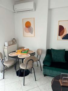 a living room with a table and chairs and a couch at The View Xanthi in Xanthi