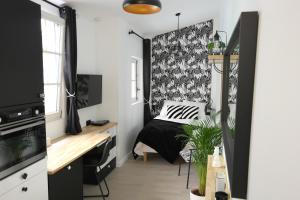 a bedroom with a bed and a desk in it at La Joueuse, Et pop Et Chic ! in Poitiers