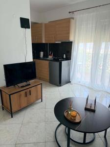 a living room with a table and a kitchen at The View Xanthi in Xanthi +2 photos