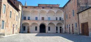 an alleyway in an old building with a gate at Palazzo TEDESCHI in Borgonovo Val Tidone