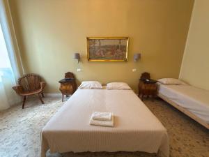 a bedroom with two beds and a picture on the wall at Palazzo TEDESCHI in Borgonovo Val Tidone +6 photos