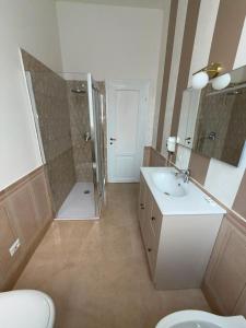 a bathroom with a sink and a shower and a toilet at Palazzo TEDESCHI in Borgonovo Val Tidone