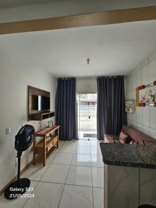 a living room with a couch and a table at Apart ZSS in Penha