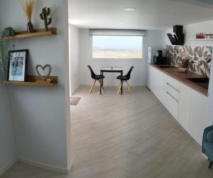 a kitchen and dining room with a table and chairs at Gratitud Un refugio con encanto in Soo