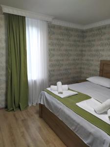 a hotel room with a bed and a window at Vardzia Old Village in Vardzia