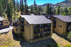 an aerial view of a large yellow apartment building at Chez Vaupen in Alpine Meadows