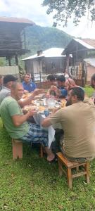 a group of people sitting at a table eating at wila ZUNDAGA ზუნდაგა 1800 in Zundaga