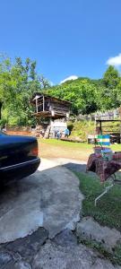 a car parked in front of a yard with a house at wila ZUNDAGA ზუნდაგა 1800 in Zundaga