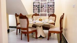 a dining room with a table and chairs at Godly Homes 5km frm Weiteithie! 4BR mdrn home in Ruiru