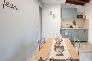 a table with a picture of a woman on it in a kitchen at Amò Casa in Fiumefreddo di Sicilia
