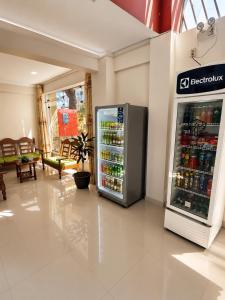 a refrigerator in a store with drinks in it at La Posada Del Pajarito in Yurimaguas