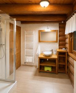 a bathroom with a sink and a mirror and a shower at Chalet Velora in Oščadnica +38 photos