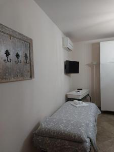a small bedroom with a bed and a tv at appartamento Podere i Renai in Santa Maria a Monte