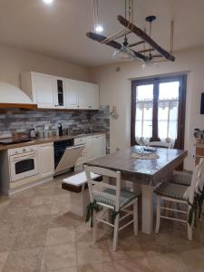 a kitchen with a table and chairs in a room at appartamento Podere i Renai in Santa Maria a Monte