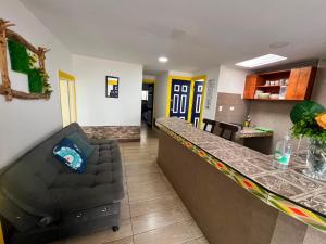 a living room with a bar and a couch at Apartahotel Casa Azul Salento in Salento +13 photos