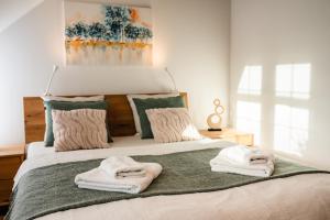 a bedroom with a bed with towels on it at Apartmán na Pasekách in Bystrzyca