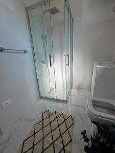 a bathroom with a glass shower and a sink at Luka Vacation House in Ulcinj +1 photo