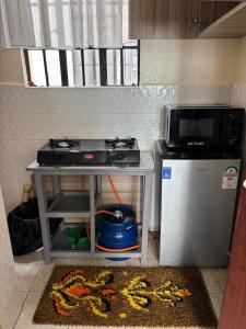 a kitchen with a stove and a small refrigerator at Prestige apartments Machakos in Machakos