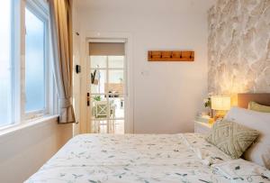 a bedroom with a large bed and a window at Lou-Lou in Zandvoort