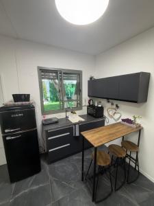 a kitchen with a table and a sink and a stove at Sweet in Nahariyya